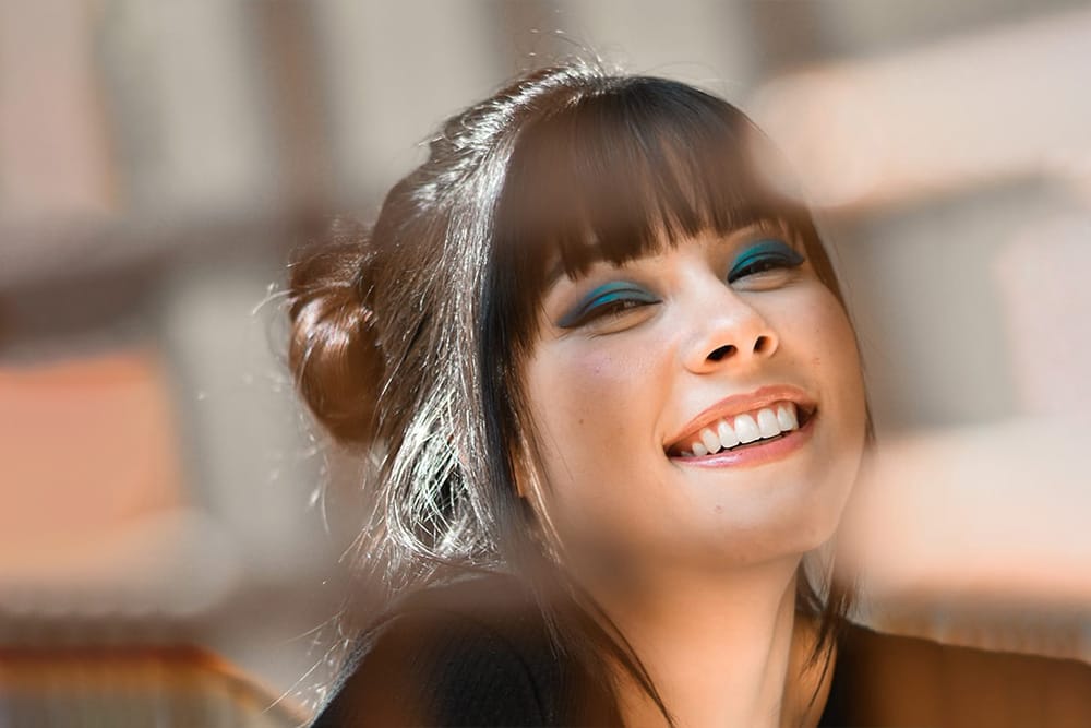 Smiling Girl Showing Off Her Porcelain Veneers